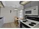 Efficient kitchen includes an oven, microwave, and dining nook, bathed in natural light from the window at 3268 39Th S St # A, St Petersburg, FL 33711