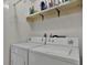 Functional laundry area equipped with a washer and dryer and convenient shelving at 3268 39Th S St # A, St Petersburg, FL 33711