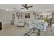 Cozy living room featuring bright carpet, floral patterned sofa, and a clear view of the dining area at 3268 39Th S St # A, St Petersburg, FL 33711
