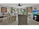 Open living room with plush sofas, soft carpet, and many windows allowing for lots of light at 3268 39Th S St # A, St Petersburg, FL 33711