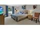 Serene bedroom with a queen bed, complemented by blue accents and natural light streaming through the window at 3268 39Th S St # A, St Petersburg, FL 33711