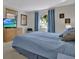 Bright main bedroom with a queen bed, offering views through a window and a comfortable seating area at 3268 39Th S St # A, St Petersburg, FL 33711