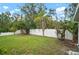 Backyard view of the white vinyl fence and lush greenery at 3908 Douglas Hill Pl, Parrish, FL 34219