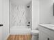 Modern bathroom with stylish marble tile in shower, and updated fixtures at 3908 Douglas Hill Pl, Parrish, FL 34219