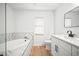 Bright bathroom features stand alone tub, modern vanity with quartz countertop, plus matte black fixtures at 3908 Douglas Hill Pl, Parrish, FL 34219