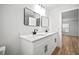 Bright bathroom features dual sinks with modern vanities and quartz countertops, plus matte black fixtures at 3908 Douglas Hill Pl, Parrish, FL 34219