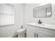 Bright bathroom featuring a white toilet, modern vanity with quartz countertop, and matte black plumbing fixtures at 3908 Douglas Hill Pl, Parrish, FL 34219