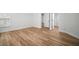 A spacious bedroom with neutral walls and wood-look flooring; closet, doorway, and double-hung window visible at 3908 Douglas Hill Pl, Parrish, FL 34219