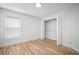 Well-lit bedroom features a closet, a window, and wood-look floors at 3908 Douglas Hill Pl, Parrish, FL 34219