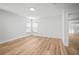 A spacious bedroom with neutral walls, wood-look flooring and two double-hung windows at 3908 Douglas Hill Pl, Parrish, FL 34219