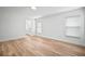 Bright bedroom with wood-look flooring and view of ensuite bathroom featuring a modern vanity at 3908 Douglas Hill Pl, Parrish, FL 34219