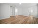 A spacious bedroom with neutral walls, wood-look flooring, view of closet and ensuite bathroom at 3908 Douglas Hill Pl, Parrish, FL 34219