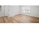 Bright bedroom with sleek modern flooring, white walls, a large window, and natural lighting at 3908 Douglas Hill Pl, Parrish, FL 34219