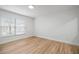 Bright bedroom with neutral walls, wood floors, and a window bringing in natural light at 3908 Douglas Hill Pl, Parrish, FL 34219