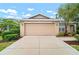 Charming home featuring an attached two-car garage, a well-manicured lawn, and beautiful landscaping at 3908 Douglas Hill Pl, Parrish, FL 34219