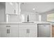 Bright kitchen with stainless steel appliances, quartz countertops, and white cabinets at 3908 Douglas Hill Pl, Parrish, FL 34219