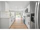 Bright kitchen with stainless steel appliances, white cabinets, and a backyard view at 3908 Douglas Hill Pl, Parrish, FL 34219