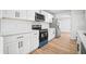 Bright kitchen featuring stainless steel appliances, quartz countertops, and white cabinets at 3908 Douglas Hill Pl, Parrish, FL 34219