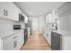 Open kitchen featuring stainless appliances, white cabinetry, and quartz countertops at 3908 Douglas Hill Pl, Parrish, FL 34219