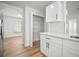 Modern kitchen with stainless steel appliances, quartz countertops, white cabinets, and pantry at 3908 Douglas Hill Pl, Parrish, FL 34219