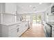 Bright kitchen with white cabinetry and quartz countertops, overlooking the backyard at 3908 Douglas Hill Pl, Parrish, FL 34219