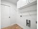 Bright laundry room with washer and dryer hookups and storage shelves at 3908 Douglas Hill Pl, Parrish, FL 34219