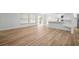 Bright living area with hardwood floors, white walls, and view of the backyard through sliding glass doors at 3908 Douglas Hill Pl, Parrish, FL 34219