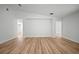 Spacious open-plan room showcasing wood floors and a minimalist, bright interior at 3908 Douglas Hill Pl, Parrish, FL 34219