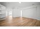Open-concept living space showcasing sleek, minimalist design and expansive wood flooring at 3908 Douglas Hill Pl, Parrish, FL 34219