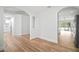 Spacious living area featuring wood flooring, arched doorways, and access to kitchen at 3908 Douglas Hill Pl, Parrish, FL 34219