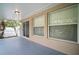 Covered outdoor patio area with view of the yard and lush landscaping at 3908 Douglas Hill Pl, Parrish, FL 34219