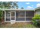 Screened in porch with tiled floor and backyard view at 3908 Douglas Hill Pl, Parrish, FL 34219