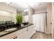 Bathroom with double sinks, granite countertops, vanity, tile floor, and laundry at 4345 Bayside Village Dr # 303, Tampa, FL 33615