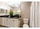 Bathroom with granite countertops and double sinks with laundry in the background at 4345 Bayside Village Dr # 303, Tampa, FL 33615