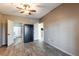 Bedroom with neutral paint and wood-look tile flooring and a view into the kitchen at 4345 Bayside Village Dr # 303, Tampa, FL 33615