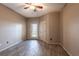 Bedroom featuring wood-look tile flooring, ceiling fan, and an exterior door at 4345 Bayside Village Dr # 303, Tampa, FL 33615