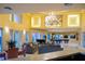 Well-lit clubhouse featuring lounge seating, chandeliers, a piano, and pool tables at 4345 Bayside Village Dr # 303, Tampa, FL 33615