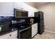 Well-lit kitchen showcasing stainless steel appliances, granite counters, and white cabinets for ample storage at 4345 Bayside Village Dr # 303, Tampa, FL 33615