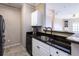 Stylish kitchen area with black granite countertops, white cabinets, and stainless steel appliances at 4345 Bayside Village Dr # 303, Tampa, FL 33615