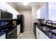 Bright kitchen featuring granite countertops, modern appliances, white cabinetry, and tile flooring at 4345 Bayside Village Dr # 303, Tampa, FL 33615