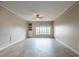 Bright living room features neutral paint, tiled floors, ceiling fan and large window at 4345 Bayside Village Dr # 303, Tampa, FL 33615