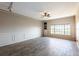 Bright living room features neutral paint, tiled floors, ceiling fan and large window at 4345 Bayside Village Dr # 303, Tampa, FL 33615