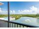 Screened balcony view of pond, fountain, mangroves, skyline and community pool in distance at 4345 Bayside Village Dr # 303, Tampa, FL 33615