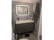 Stylish bathroom with a modern vanity, illuminated mirror, and elegant gray tile at 4705 Ne 1St Ne St # 327, St Petersburg, FL 33703
