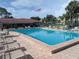Sparkling community pool area with lounge chairs, tables, and a view of the clubhouse at 4705 Ne 1St Ne St # 327, St Petersburg, FL 33703