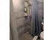 Modern shower featuring beautiful gray tile, rainfall shower head, and convenient shelving at 4705 Ne 1St Ne St # 327, St Petersburg, FL 33703
