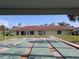 Community shuffleboard courts and clubhouse, providing a recreational and social gathering spot at 4705 Ne 1St Ne St # 327, St Petersburg, FL 33703