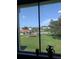 A serene view of a well-manicured lawn and a community pool from inside the home at 4705 Ne 1St Ne St # 327, St Petersburg, FL 33703