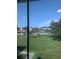 A bright view of a lush green lawn and a sparkling community pool from inside the home at 4705 Ne 1St Ne St # 327, St Petersburg, FL 33703