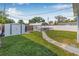 Grassy backyard featuring a storage shed and metal carport structure at 4755 21St N Ave, St Petersburg, FL 33713